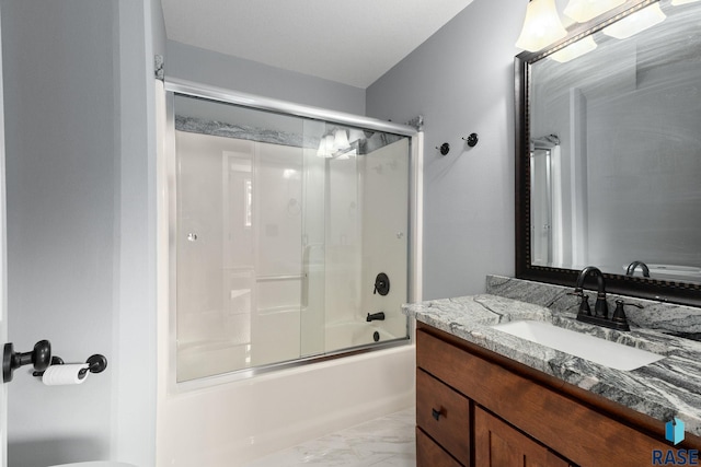 full bathroom with marble finish floor, combined bath / shower with glass door, and vanity