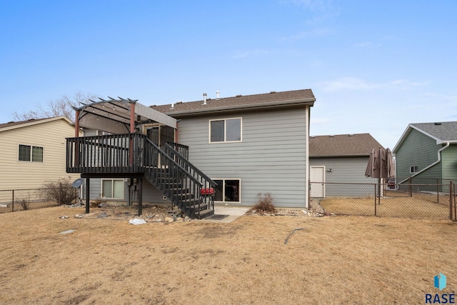 back of house featuring stairs, a yard, a deck, and a fenced backyard