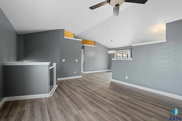 unfurnished living room with a ceiling fan, lofted ceiling, baseboards, and wood finished floors