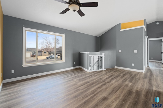 additional living space with lofted ceiling, wood finished floors, visible vents, and baseboards