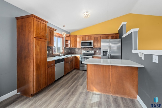 kitchen featuring open shelves, stainless steel appliances, light countertops, a sink, and a peninsula