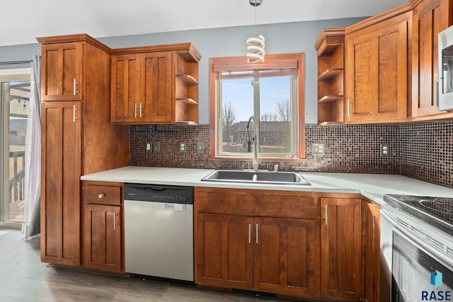 kitchen featuring open shelves, tasteful backsplash, appliances with stainless steel finishes, a sink, and wood finished floors