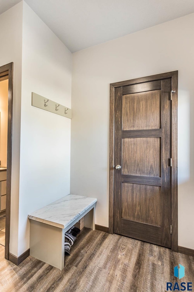 mudroom featuring baseboards and wood finished floors