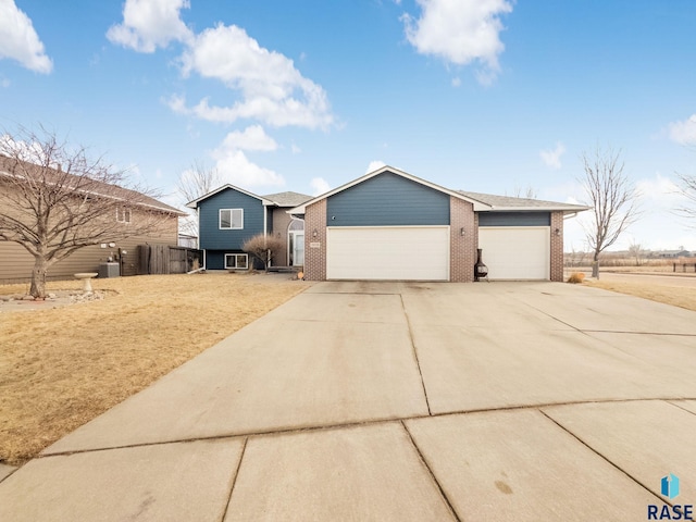 view of front of house with concrete driveway, brick siding, and an attached garage