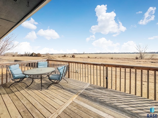 wooden deck with a rural view