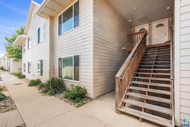 view of side of home featuring stairway