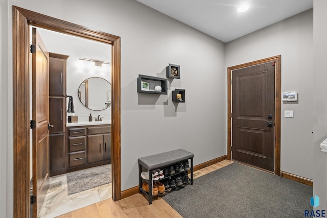 8501 E Torchwood Pl, Sioux Falls, SD 57110 - foyer with light wood-style flooring and baseboards