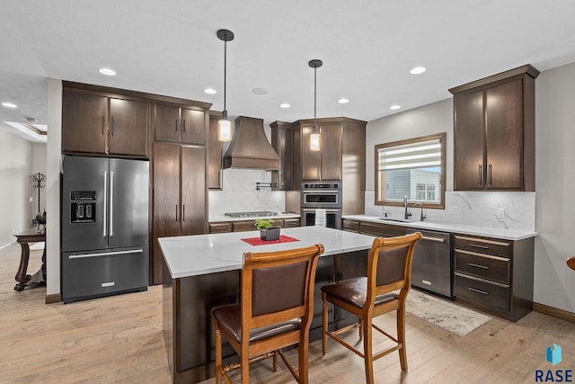 8501 E Torchwood Pl, Sioux Falls, SD 57110 - kitchen with premium range hood, dark brown cabinets, appliances with stainless steel finishes, and a sink