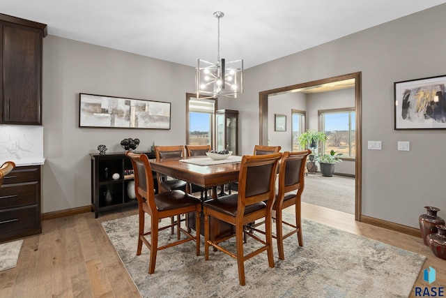 8501 E Torchwood Pl, Sioux Falls, SD 57110 - dining room featuring light wood-style floors, a notable chandelier, and baseboards