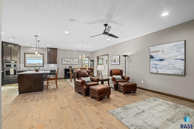 8501 E Torchwood Pl, Sioux Falls, SD 57110 - living area with light wood-style floors, recessed lighting, ceiling fan, and baseboards