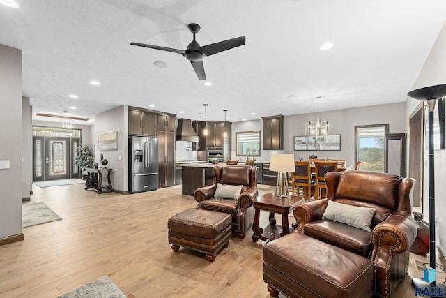 8501 E Torchwood Pl, Sioux Falls, SD 57110 - living area with ceiling fan with notable chandelier, recessed lighting, and light wood-style floors