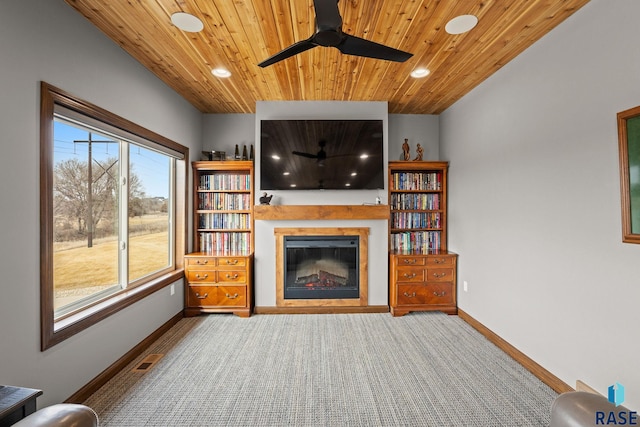 8501 E Torchwood Pl, Sioux Falls, SD 57110 - unfurnished living room with wood ceiling, visible vents, baseboards, and a glass covered fireplace