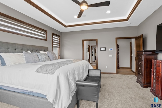 8501 E Torchwood Pl, Sioux Falls, SD 57110 - carpeted bedroom with a ceiling fan, a tray ceiling, and baseboards