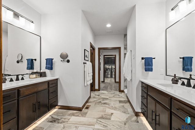 8501 E Torchwood Pl, Sioux Falls, SD 57110 - bathroom with marble finish floor, two vanities, and a sink