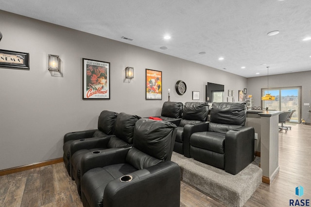 8501 E Torchwood Pl, Sioux Falls, SD 57110 - home theater room with a textured ceiling, wood finished floors, visible vents, and baseboards