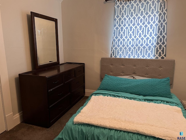 bedroom featuring dark carpet