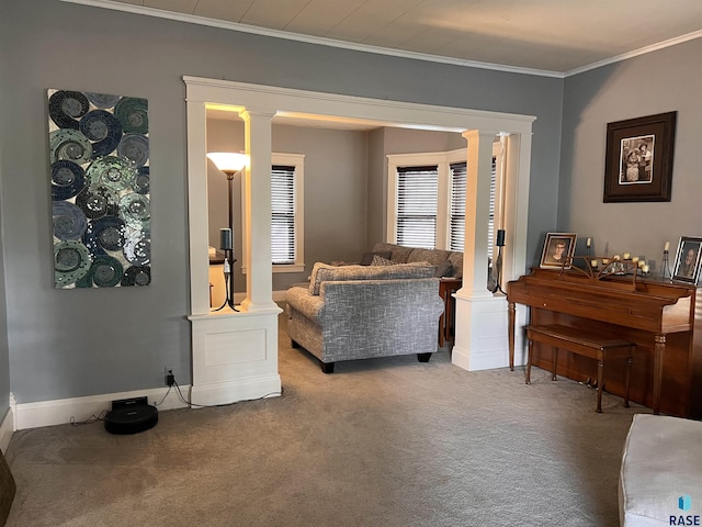 sitting room featuring carpet, decorative columns, ornamental molding, and baseboards