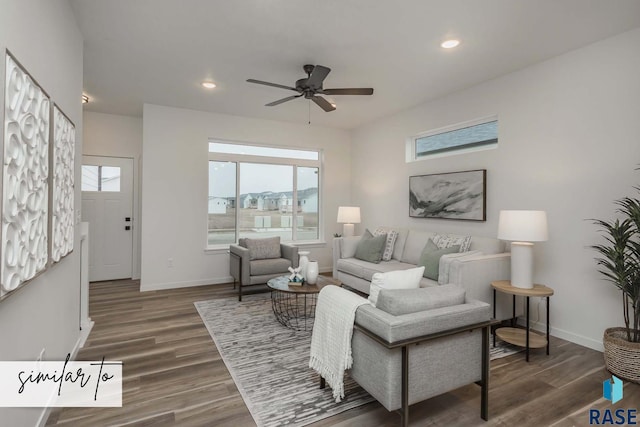 living room featuring baseboards, wood finished floors, and recessed lighting