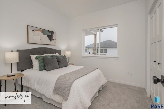 carpeted bedroom featuring a closet and baseboards