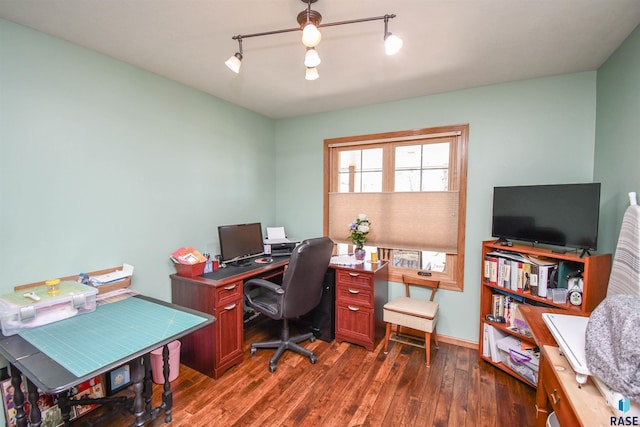 home office with baseboards, dark wood-style flooring, and track lighting