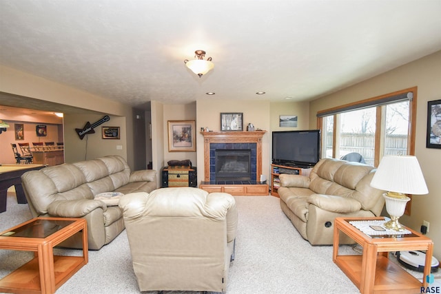 living room featuring carpet floors and a tile fireplace