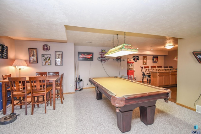 game room featuring a textured ceiling, pool table, a dry bar, and baseboards