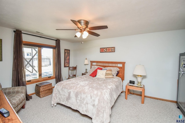 carpeted bedroom featuring a ceiling fan and baseboards