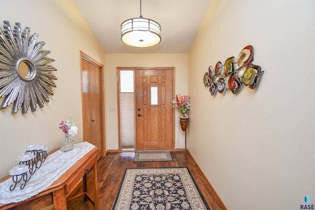 foyer with dark wood-style floors and baseboards