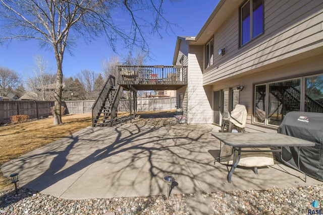 view of patio featuring a deck, stairway, grilling area, and fence