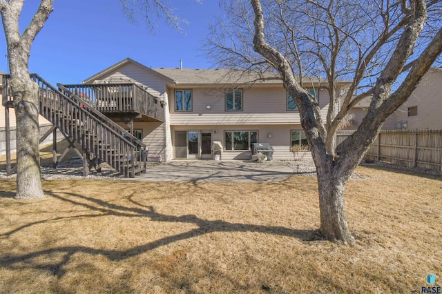 rear view of house with a patio area, stairs, fence, and a lawn