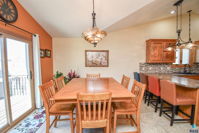 dining area featuring vaulted ceiling and light tile patterned floors