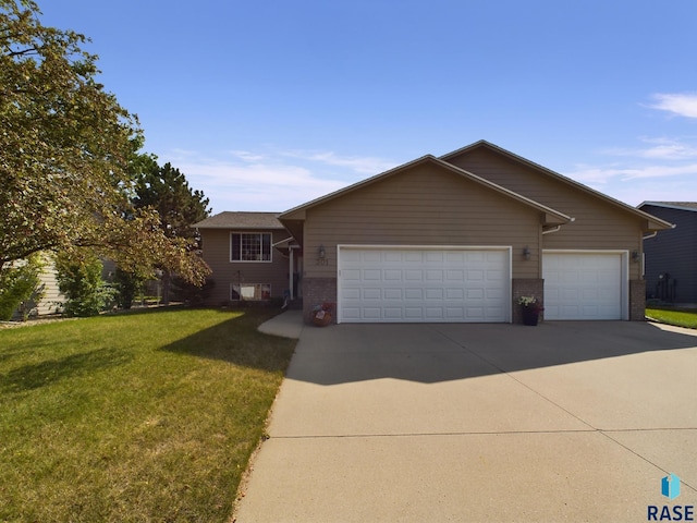 ranch-style home featuring driveway, a garage, a front lawn, and brick siding