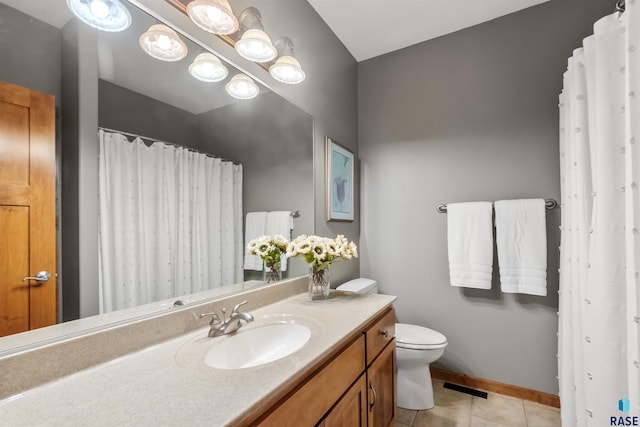 bathroom featuring visible vents, toilet, vanity, tile patterned flooring, and baseboards