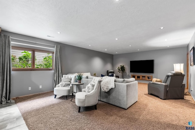 living area with a textured ceiling, baseboards, visible vents, and recessed lighting