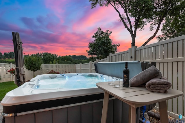 view of pool featuring a fenced backyard and a hot tub