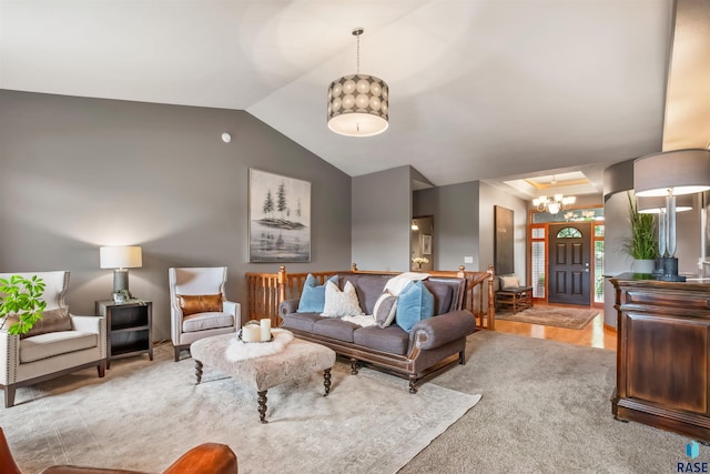 living area with lofted ceiling and a notable chandelier