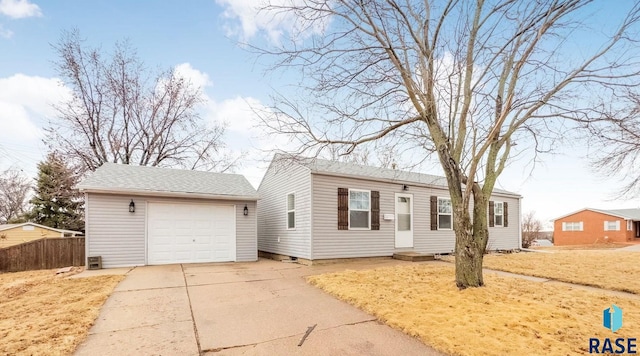 view of front of home with a shingled roof, fence, and driveway