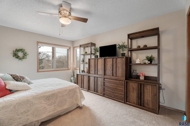 bedroom with carpet flooring, ceiling fan, and a textured ceiling