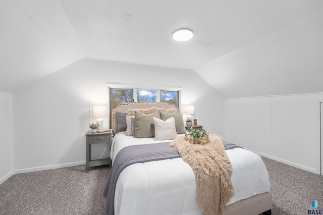 carpeted bedroom featuring vaulted ceiling and baseboards