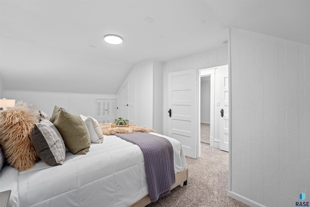 bedroom featuring lofted ceiling and carpet