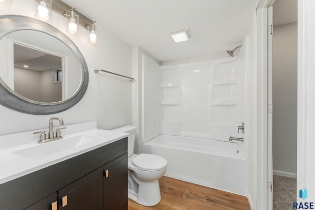 full bath with bathtub / shower combination, visible vents, toilet, vanity, and wood finished floors