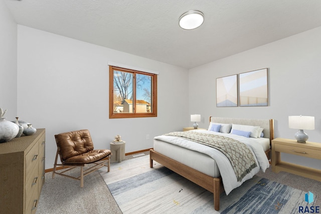 bedroom with light wood-style floors, visible vents, and baseboards