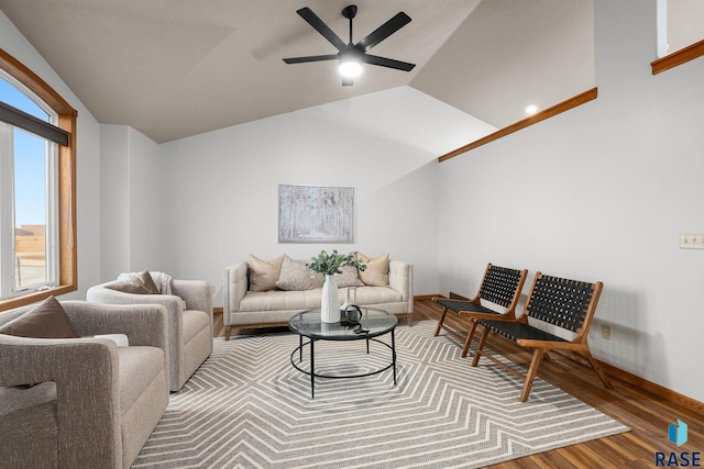 living area featuring lofted ceiling, a ceiling fan, and wood finished floors