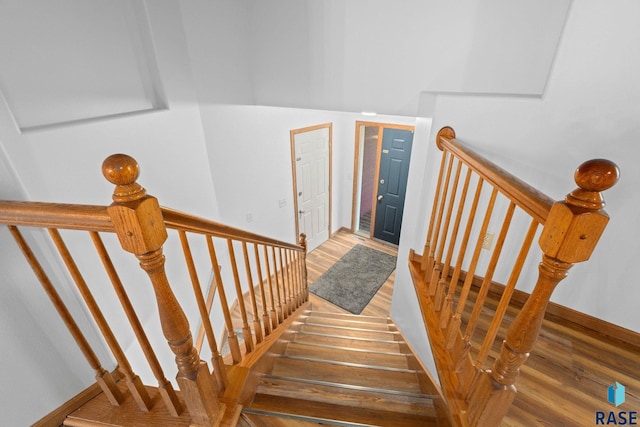 stairs with baseboards and wood finished floors