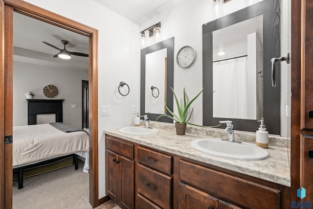 bathroom featuring double vanity, a ceiling fan, a sink, and ensuite bathroom