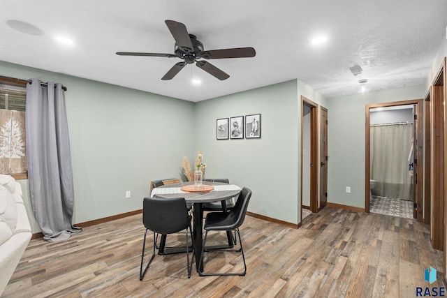 dining room featuring baseboards, ceiling fan, a textured ceiling, light wood-style floors, and recessed lighting