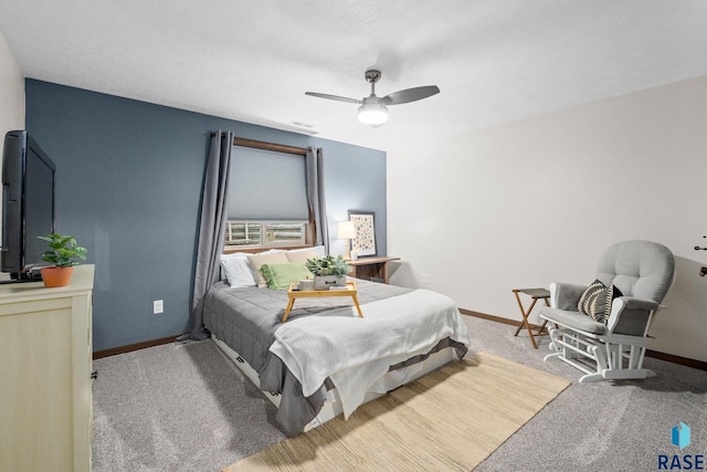 carpeted bedroom featuring ceiling fan, visible vents, and baseboards