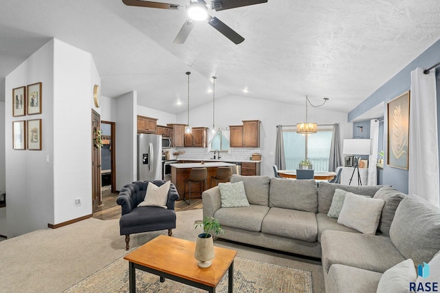 living room featuring light colored carpet, a ceiling fan, vaulted ceiling, a textured ceiling, and baseboards