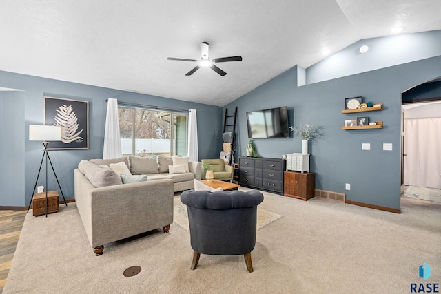 living area with lofted ceiling, ceiling fan, carpet flooring, visible vents, and baseboards