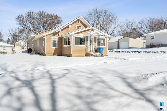 view of front of home featuring a detached garage and an outbuilding